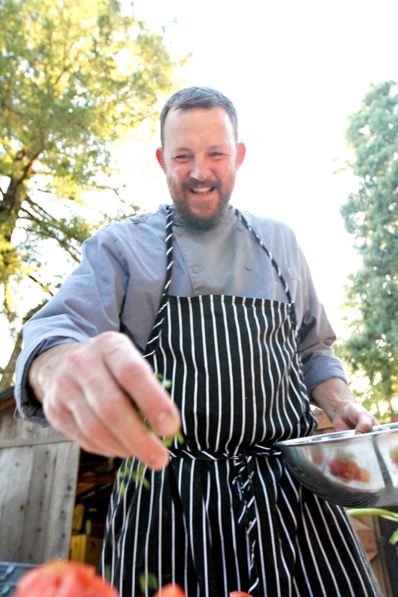 Chef Olan Cox finishes plates at Pure Mendocino.