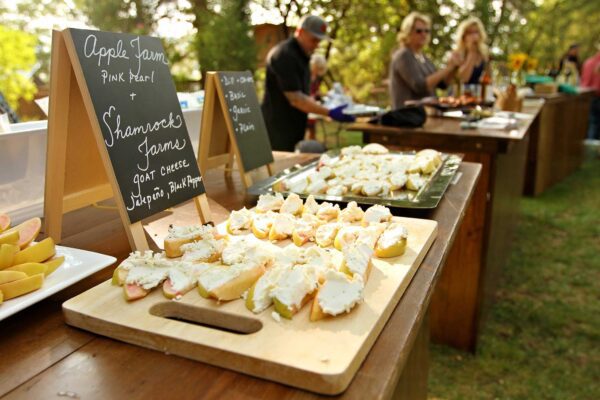 The buffet at the organic dinner offers wedges of Pink Pearl apples from the Apple Farm, covered with Shamrock Farms goat cheese.